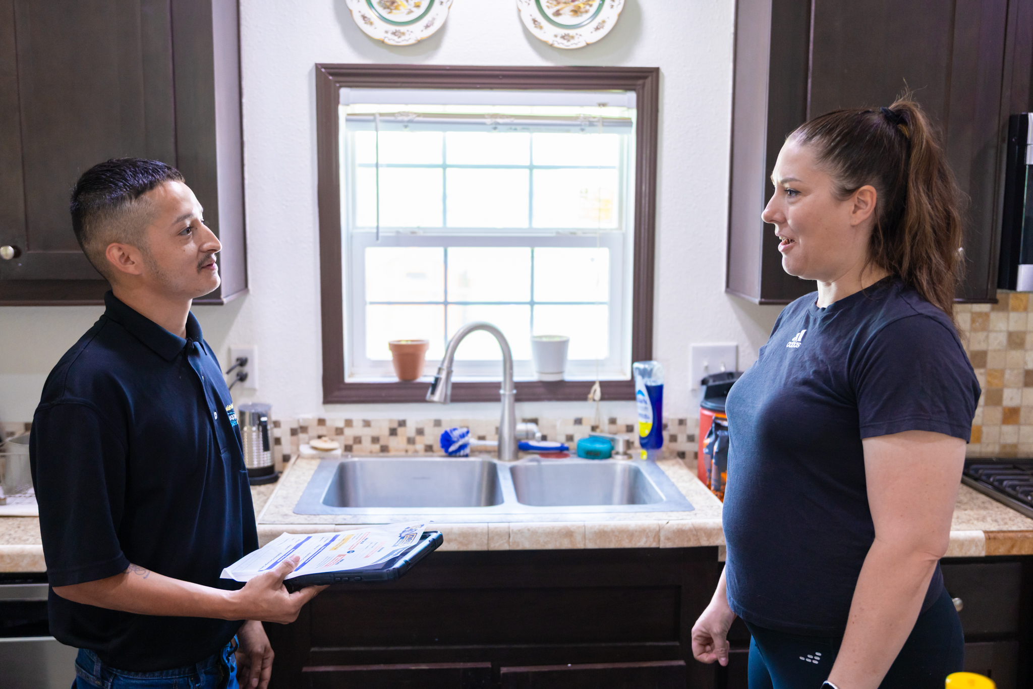 Repair technician discussing quote with customers