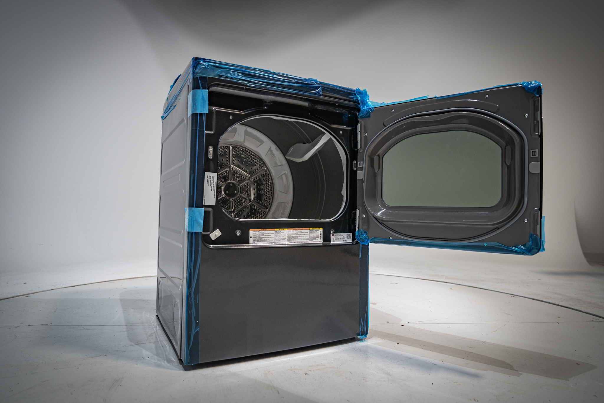 NEU Appliance Repair technician showing hidden lint buildup behind dryer vent in an Austin-area home
